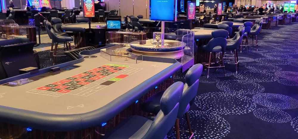 Casino floor roulette tables with SitNCharge charging