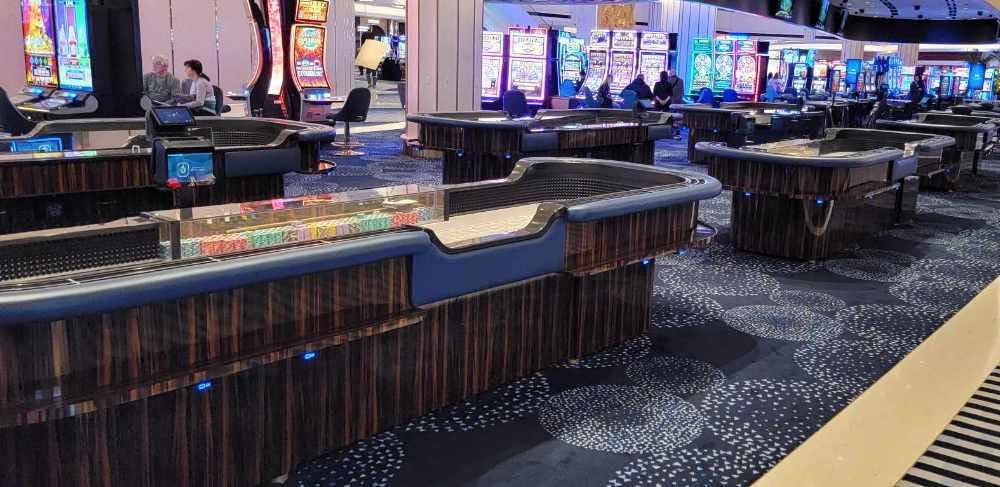 Casino gaming tables with SitNCharge blue LED charging ports
