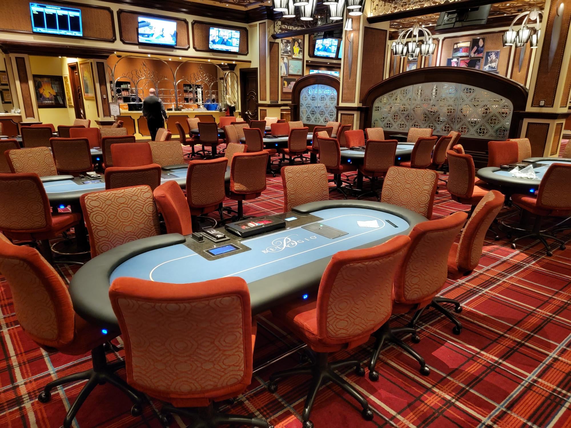 Casino poker room with blue felt tables