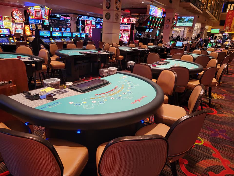 Casino floor with turquoise felt tables